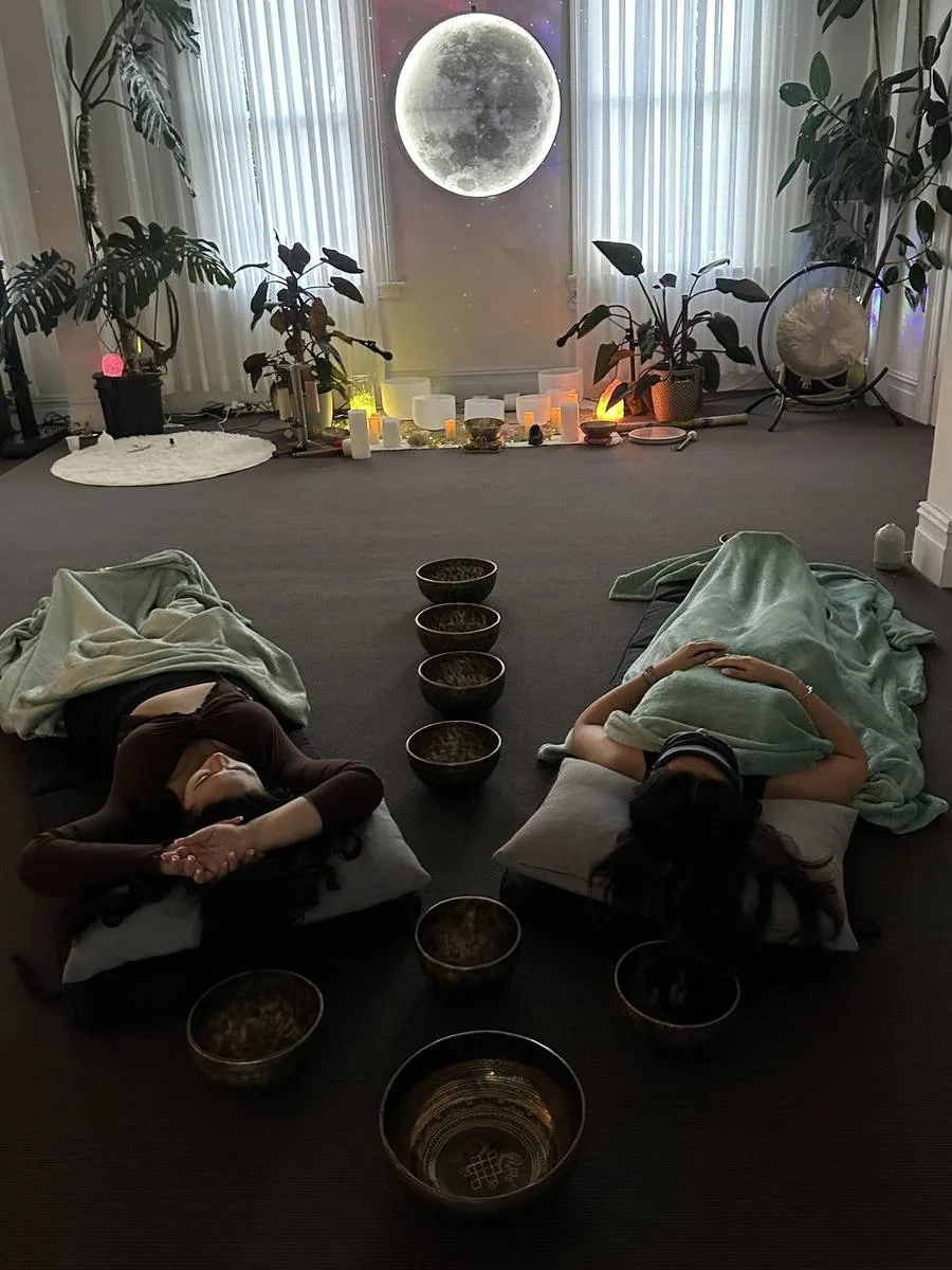 Private sound healing client resting with bowls